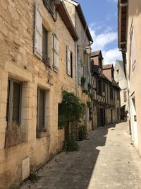 Narrow alley amidst buildings in city