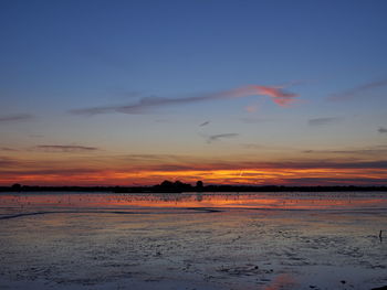 Scenic view of sea against sky at sunset