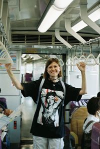 Portrait of woman with arms raised