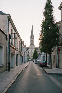 Street amidst buildings against clear sky