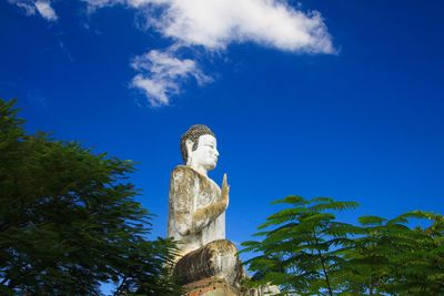 Low angle view of statue against blue sky