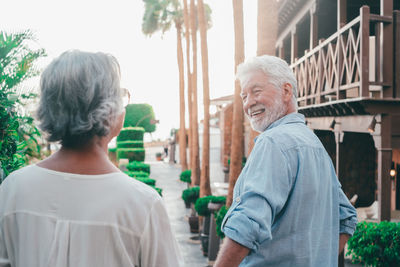 Rear view of couple standing in city