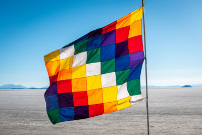 Multi colored flags against clear sky
