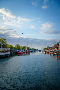 Scenic view of river against sky in city