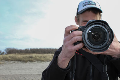 Portrait of man photographing camera