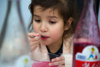 Close-up of girl drinking juice served in bowl