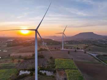 Wind farm field and sunset sky. wind power. sustainable, renewable energy. wind turbines generate