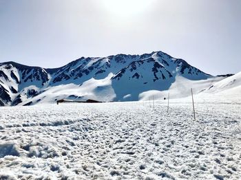 Scenic view of snow covered mountains against sky