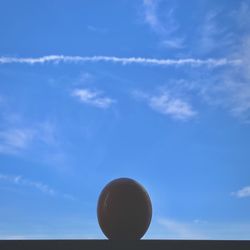 Low angle view of ball against blue sky