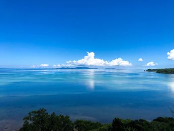 Scenic view of sea against blue sky