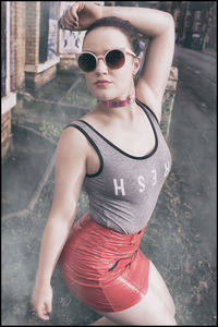 Young woman wearing sunglasses standing outdoors