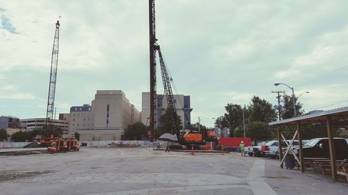 Construction site in city against sky