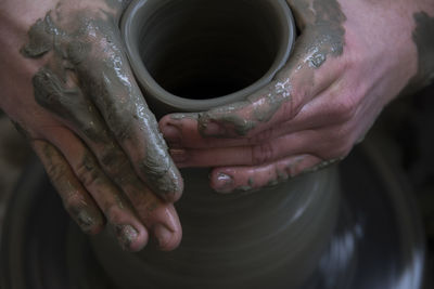 Close-up of hands making pot