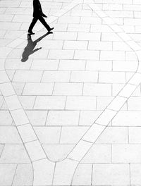 Low section of man walking on footpath