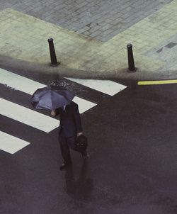 High angle view of man walking on street