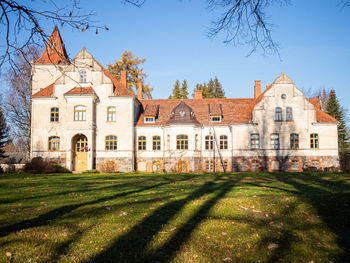 Lawn by building against sky