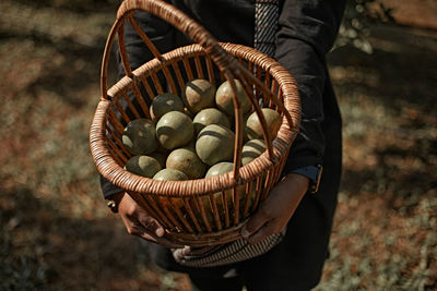 Midsection of woman holding wicker basket