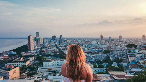 Rear view of woman looking at cityscape