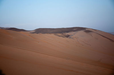 Scenic view of desert against clear sky