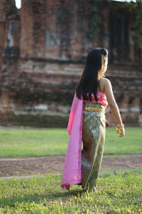 Rear view of woman on field