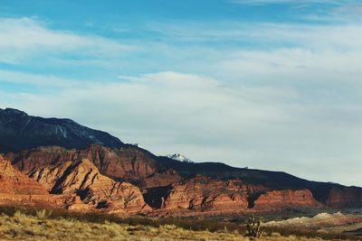 Scenic view of mountains against cloudy sky