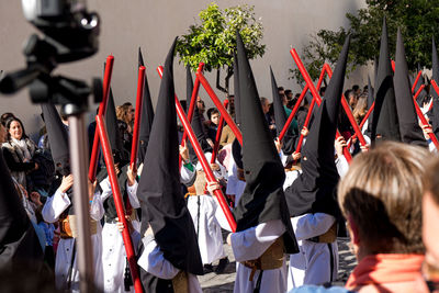 Rear view of people holding flags