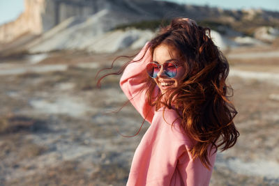 Young woman wearing sunglasses standing outdoors