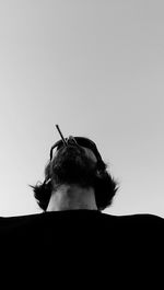 Low angle view of man against white background