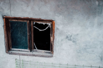 Broken window of abandoned building