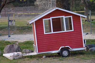 Abandoned car on field by house