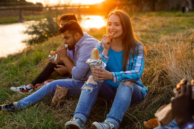 Young couple sitting on a field