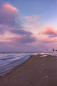 Scenic view of beach against sky during sunset