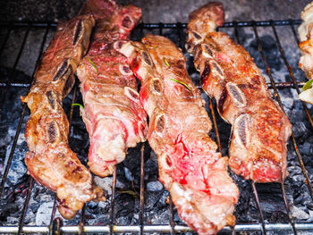 High angle view of meat on barbecue grill