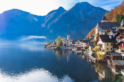 Scenic view buildings in town by lake