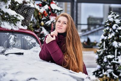 Portrait of smiling young woman during winter