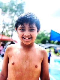 Close-up portrait of smiling shirtless boy