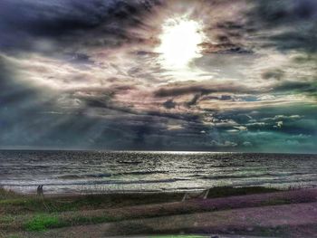 Scenic view of sea against bright sun