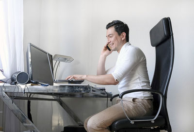 Man using mobile phone on table