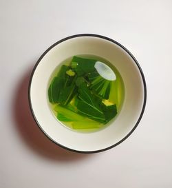 High angle view of vegetable bowl on white table