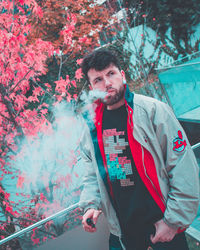 Portrait of young man standing outdoors