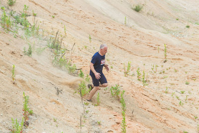 Portrait of man standing on rock