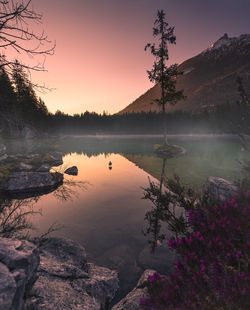 Scenic view of lake against sky at sunset