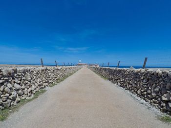 Surface level of road against blue sky