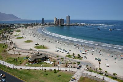 High angle view of city by sea against clear sky