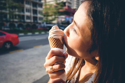 Portrait of woman ice cream cone in city