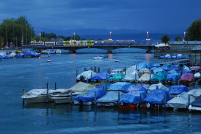 Boats moored in river against sky