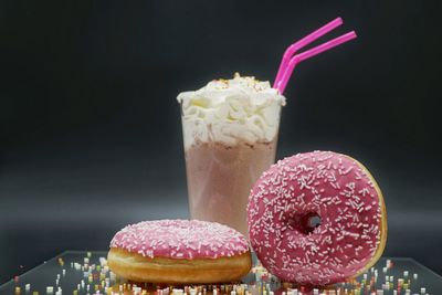 Close-up of donuts and ice cream in glass on table