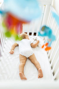 High angle view of boy sleeping on bed