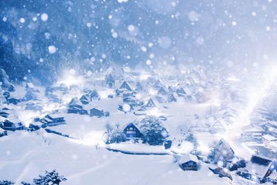 Aerial view of snowcapped landscape against blue sky
