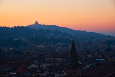 Townscape against sky during sunset
